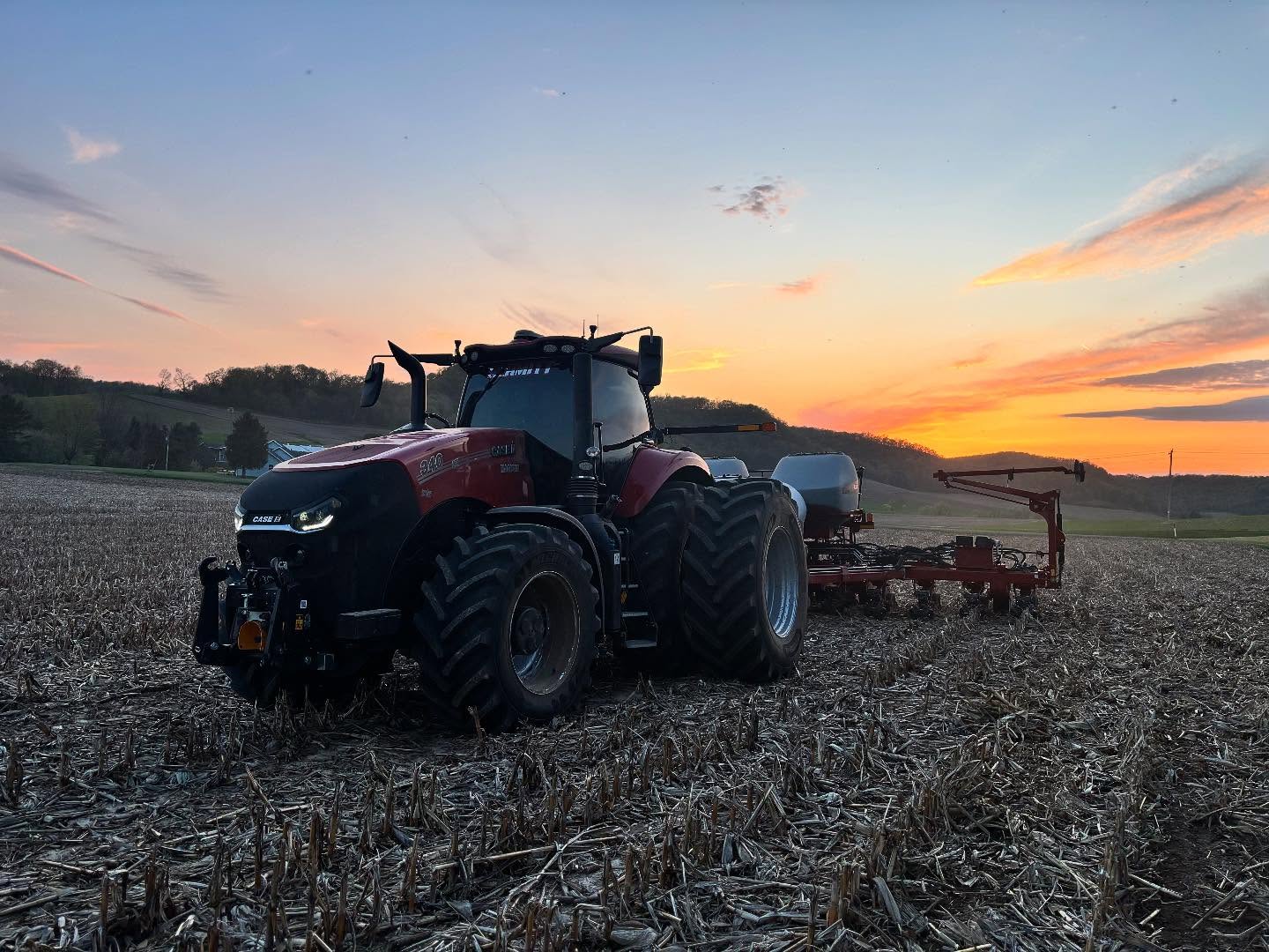 Case IH tractor planting at sunset